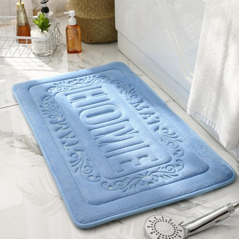 Blue rectangular bath mat with 'HOME' embossed design for bathroom.