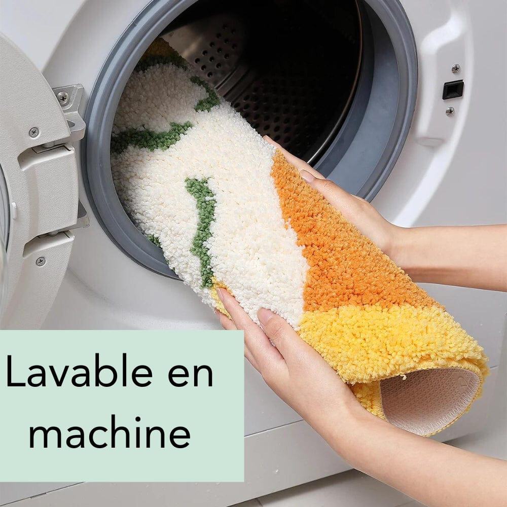 Round orange bath mat being washed in machine, machine washable.