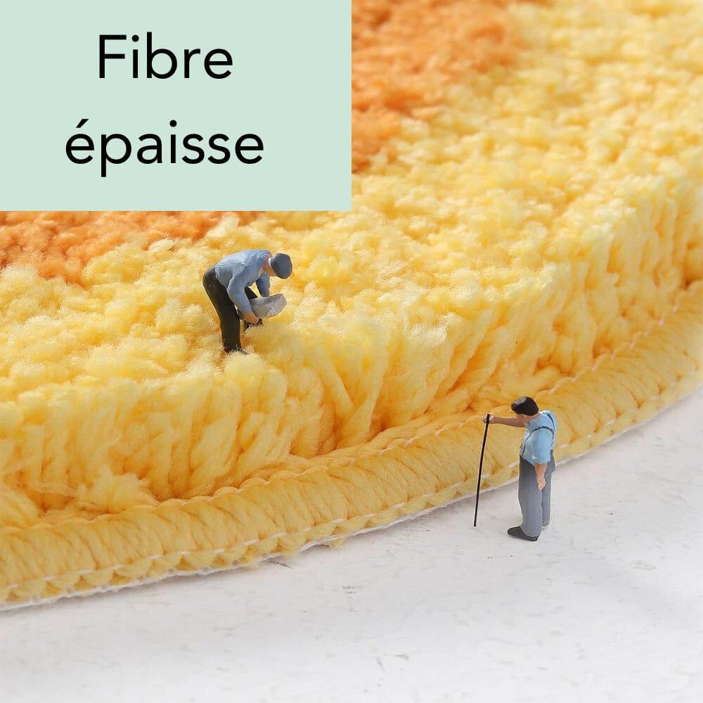 Thick fiber round orange bath mat with miniature people demonstrating plush texture.