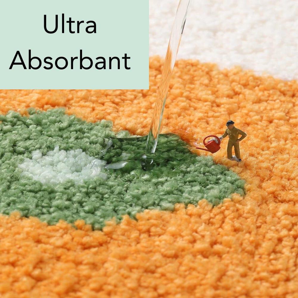 Ultra absorbent round orange bath mat with water demonstration.