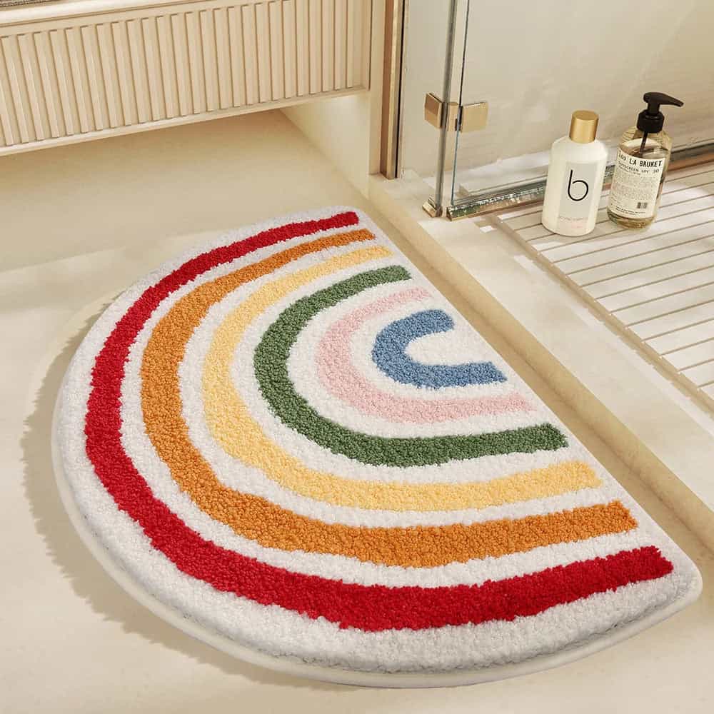 Rainbow semicircle bath mat for bathroom decor.