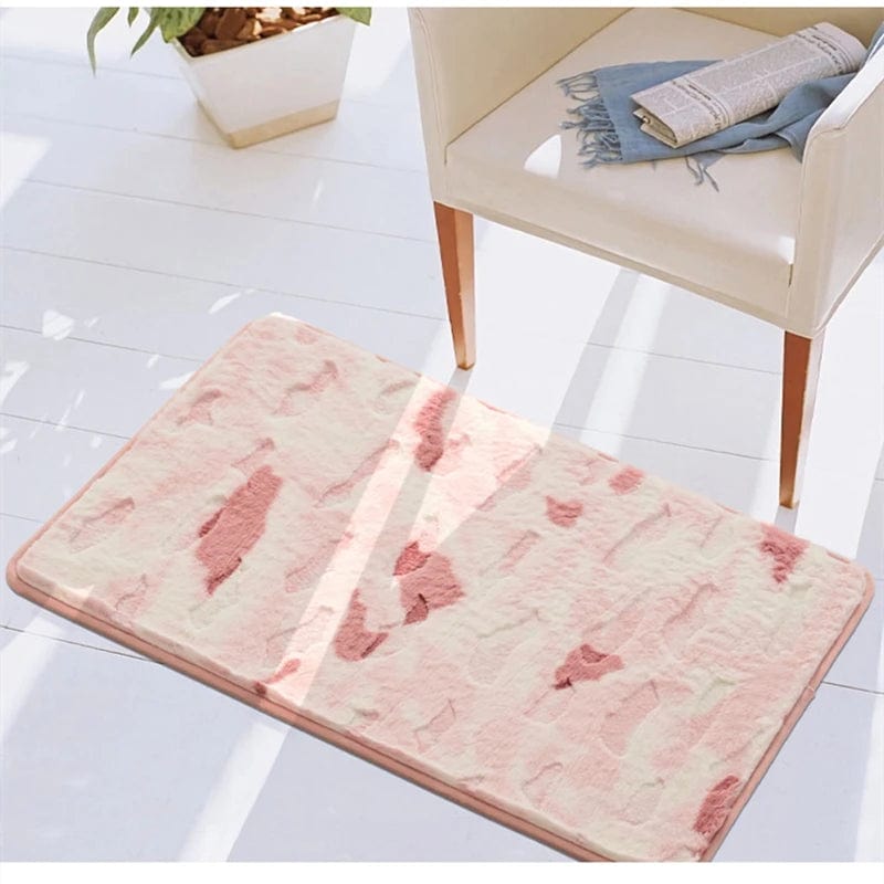 Shaggy bath mat with pink abstract pattern for cozy bathroom.