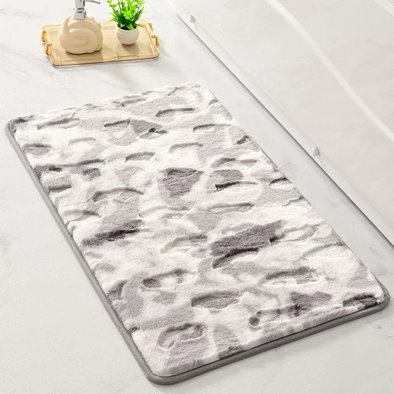 Shaggy bath mat with grey and white abstract pattern for bathroom comfort.