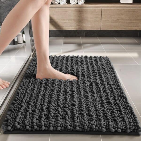 Gray textured shower bath mat with foot stepping on it for comfort and grip.