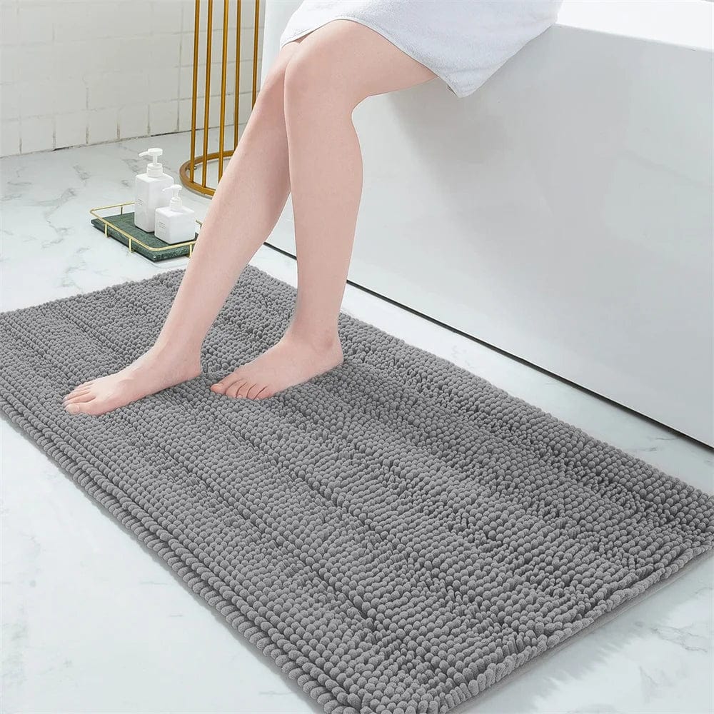 Gray fluffy bath mat for bathroom comfort and style.