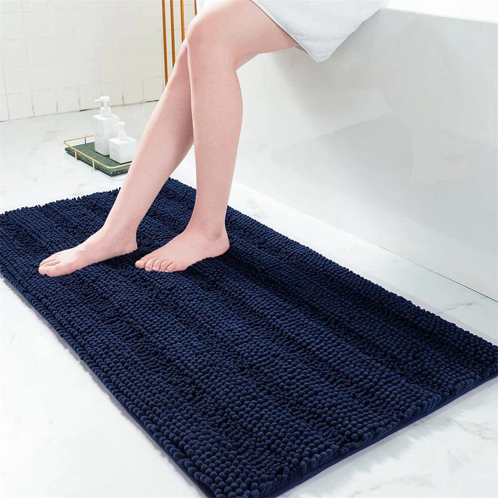 Small navy blue bath mat with textured loops for comfort and grip.