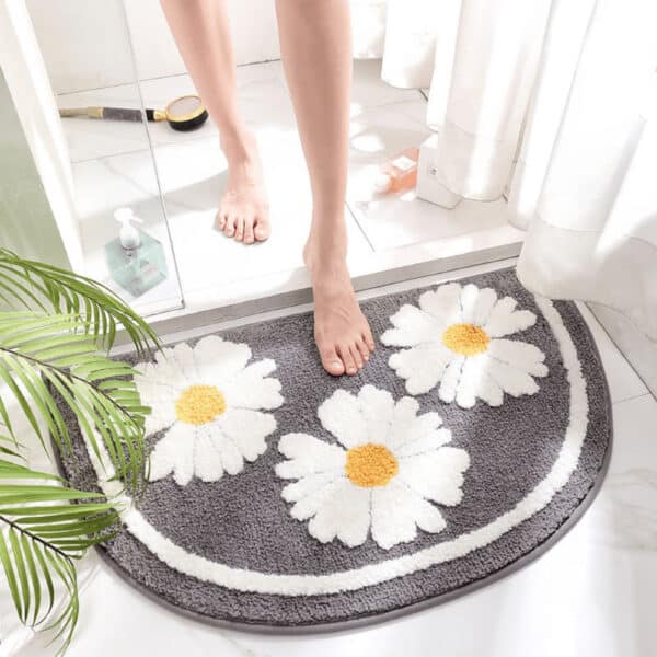 Small half moon bath mat with daisy flowers for bathroom.