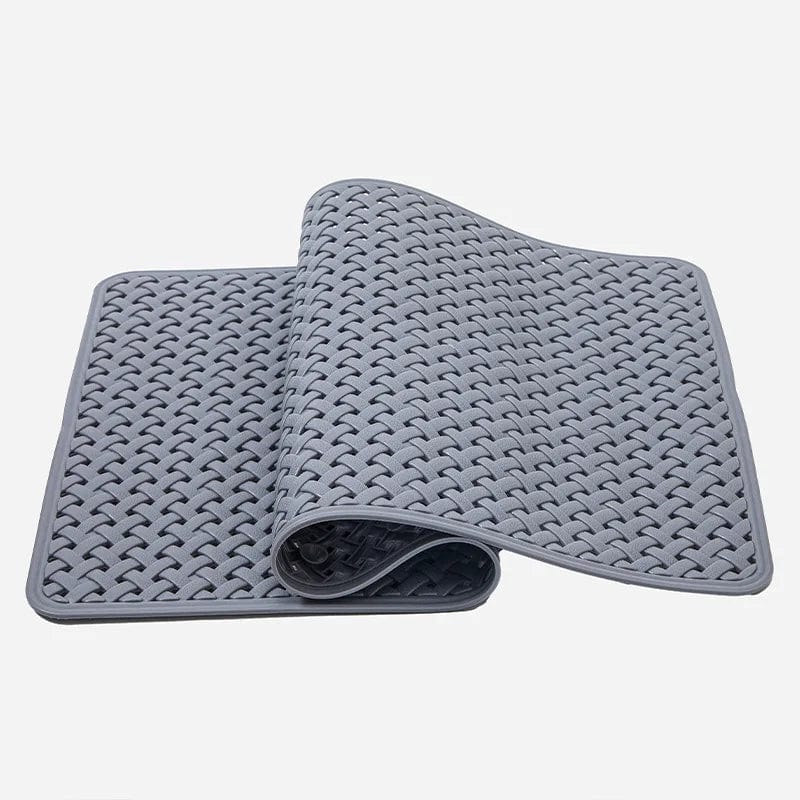 Small grey shower bath mat with textured woven design for grip and comfort.