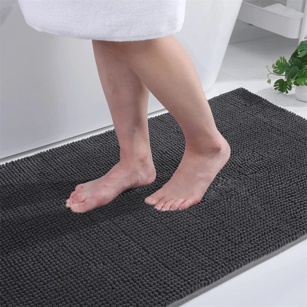 Small thin grey bath mat with textured surface for bathroom comfort.