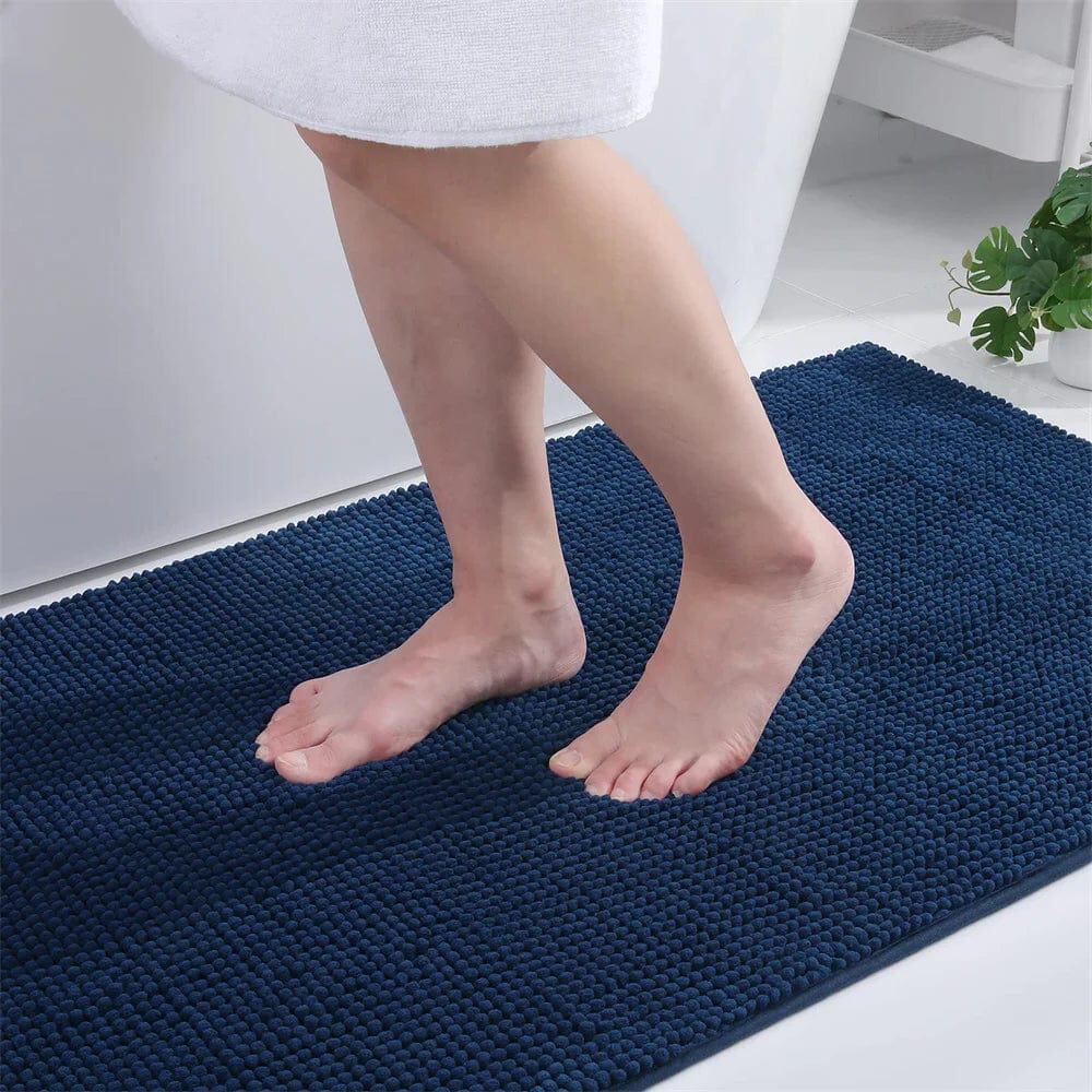 Small thin navy bath mat with textured dots for bathroom comfort.