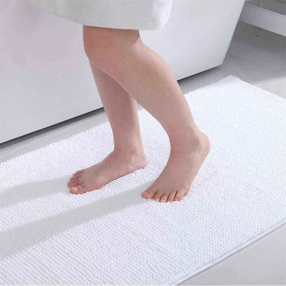 Small thin white bath mat with textured surface for bathroom use.