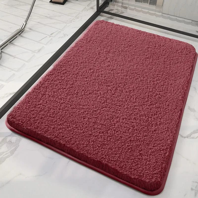 Soft red bath mat for bathroom comfort and style.