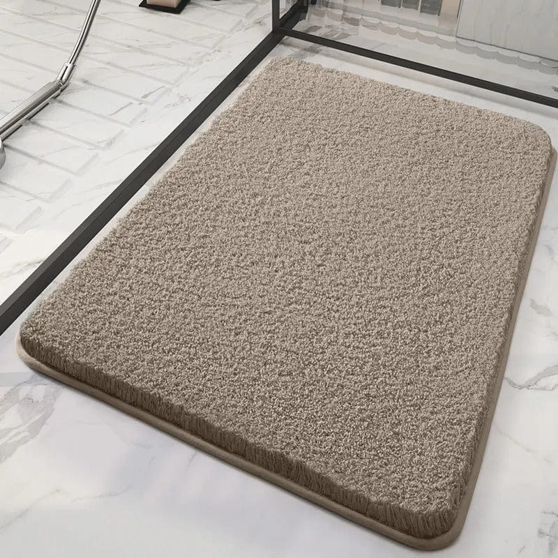 Soft beige bath mat for bathroom comfort and style.