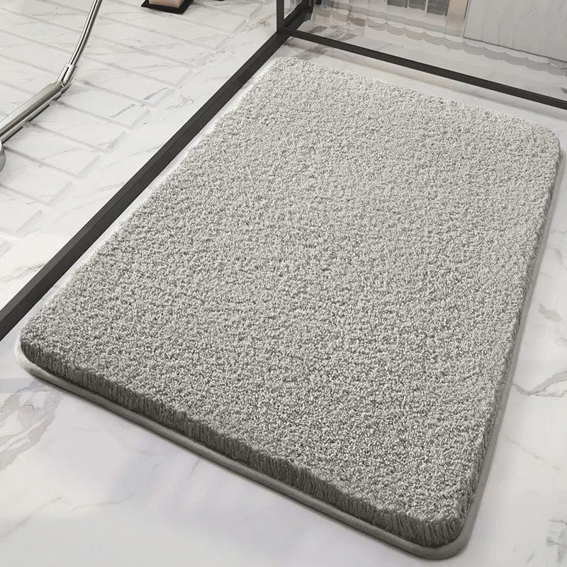 Soft grey bath mat for bathroom comfort and style.