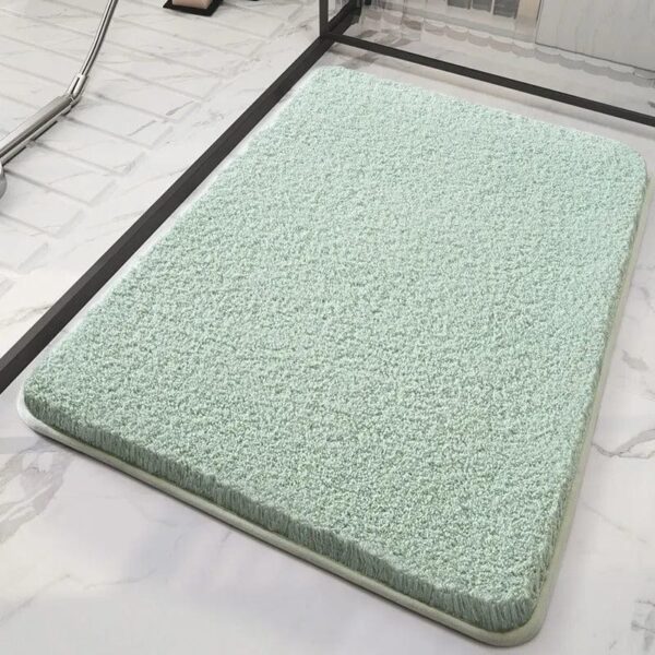 Soft mint green bath mat for bathroom comfort and style.