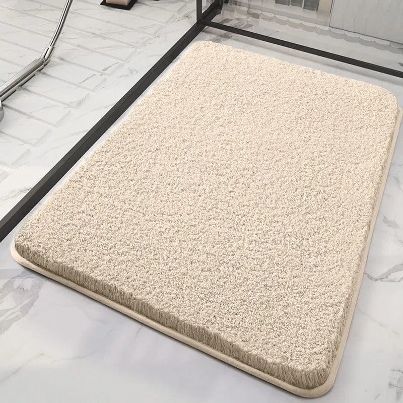 Soft beige bath mat for bathroom comfort and style.
