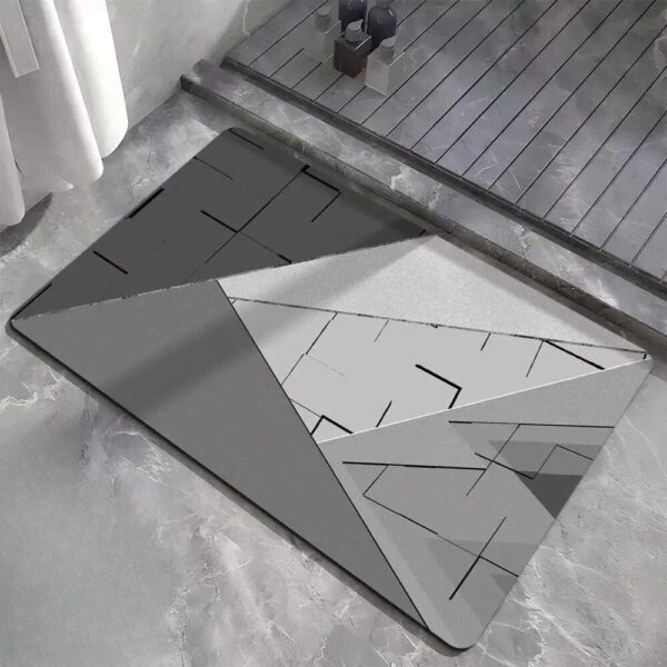 Modern geometric bath mat with grey and white abstract design for stylish bathroom.