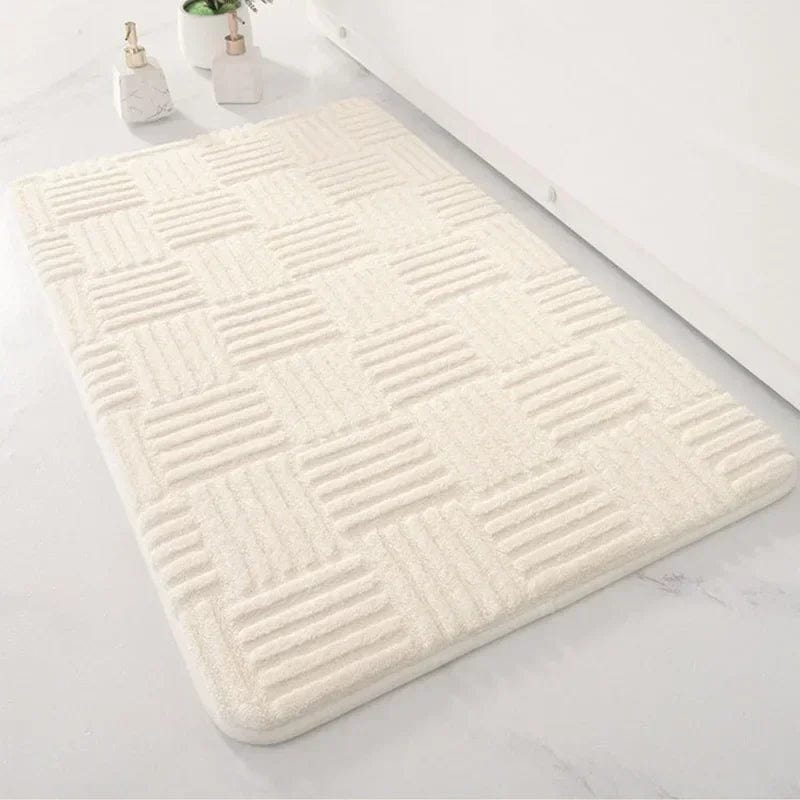 Super thick cream bath mat with textured pattern for bathroom comfort.