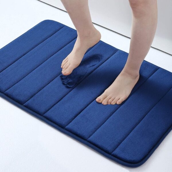 Thick blue bath mat with textured cushioning for comfort and grip.