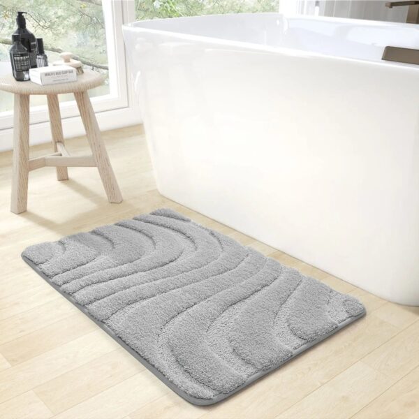 Thick grey bath mat with wavy texture for modern bathroom.