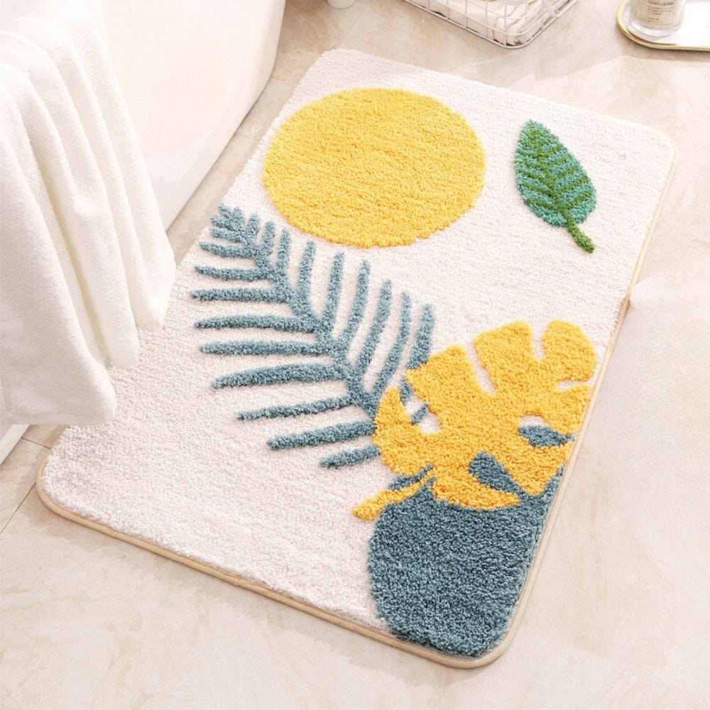 Tranquil Beauty Bath Mat with Tropical Leaf and Sun Design.