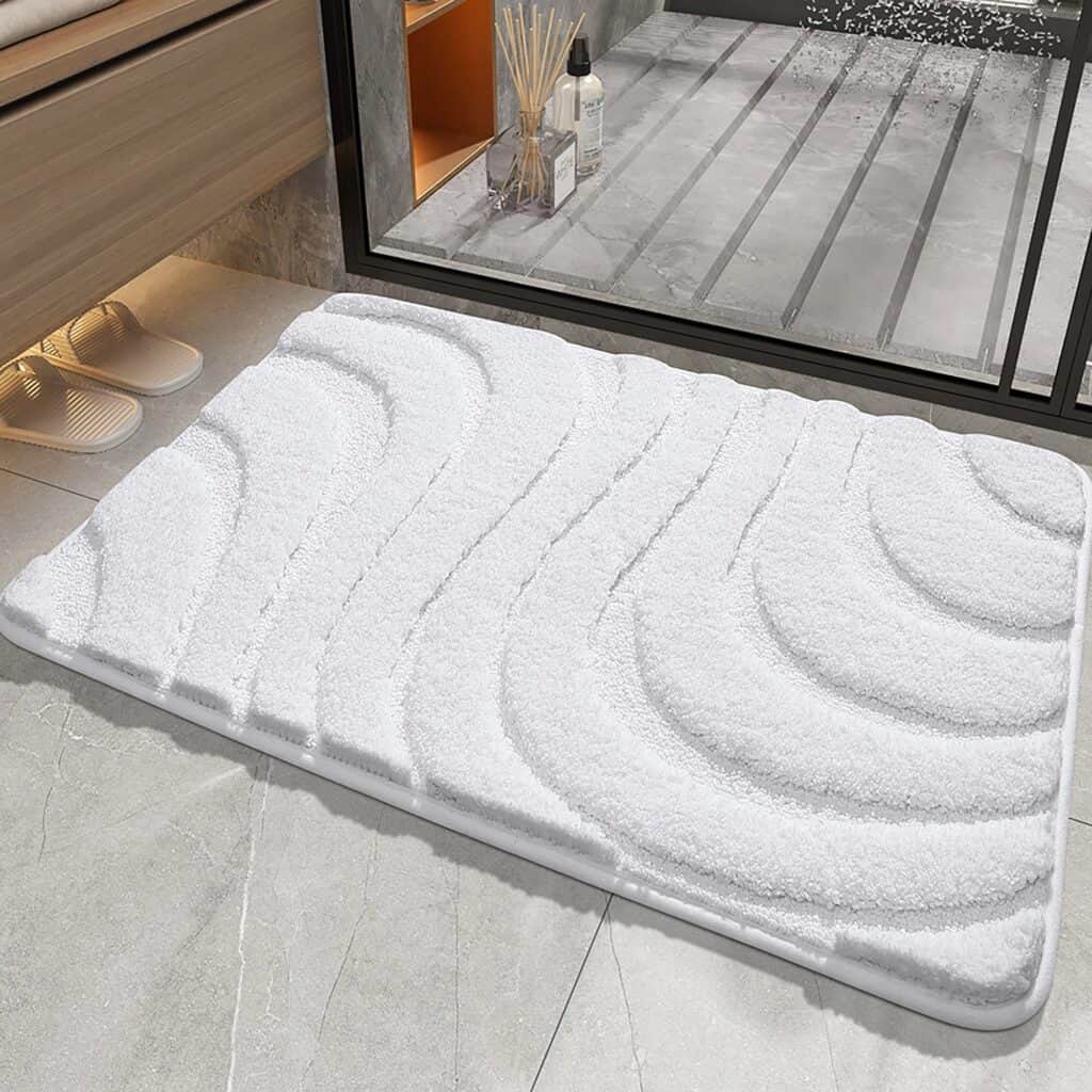 White luxury bath mat with wave pattern for modern bathroom.