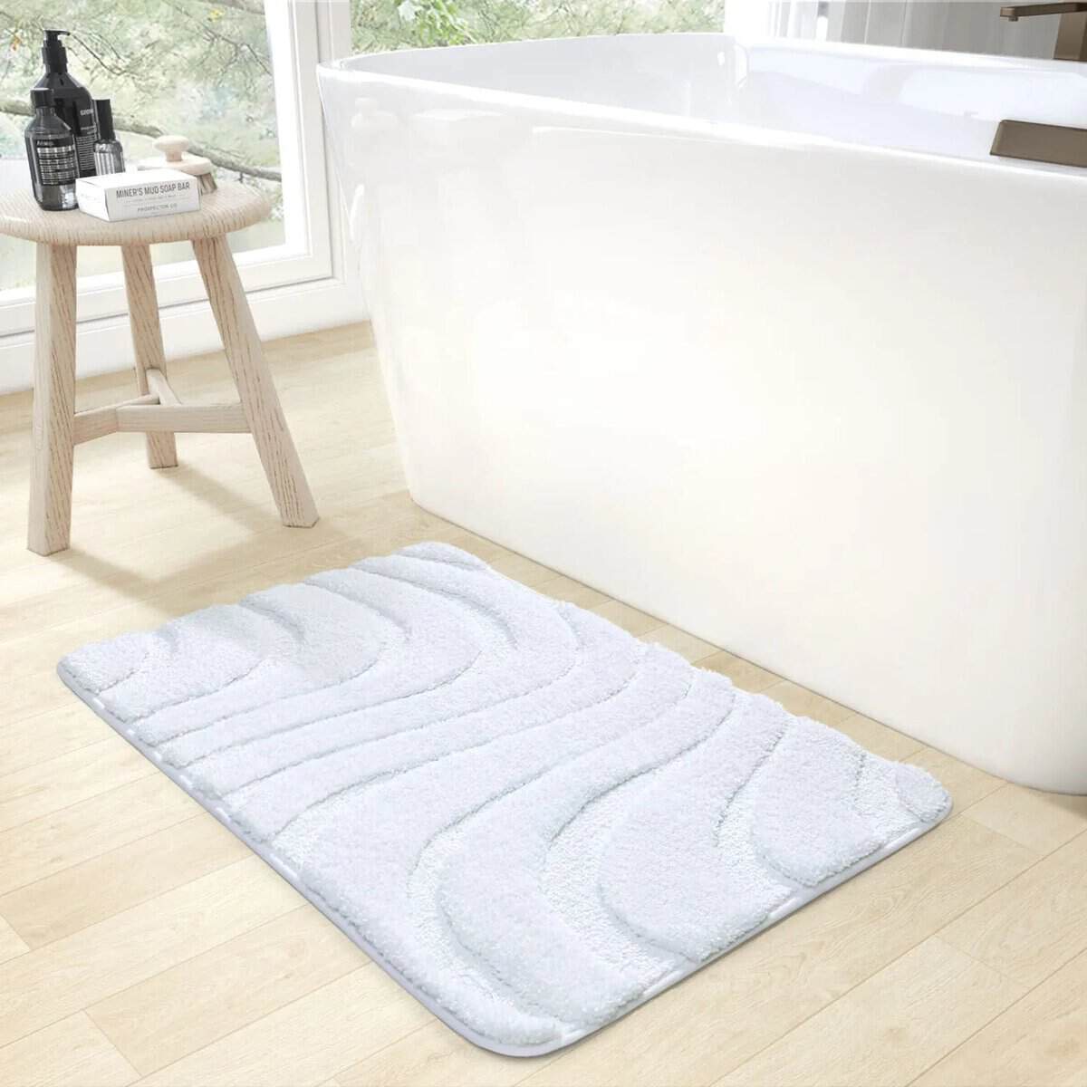 White luxury bath mat with wave pattern for modern bathroom.